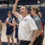 Coach Stadelman waves from on court