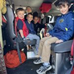 Students smile in a fire truck