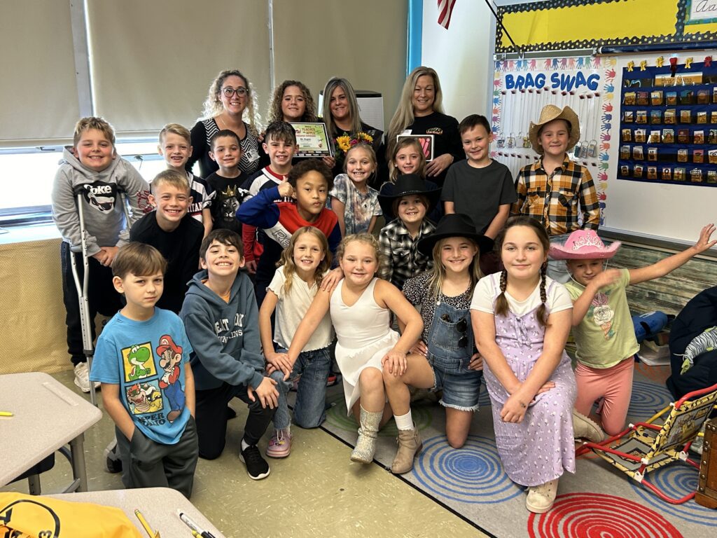 Students in cowboy duds pose with Ms. Dugan