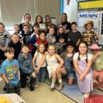 Students in cowboy duds pose with Ms. Dugan