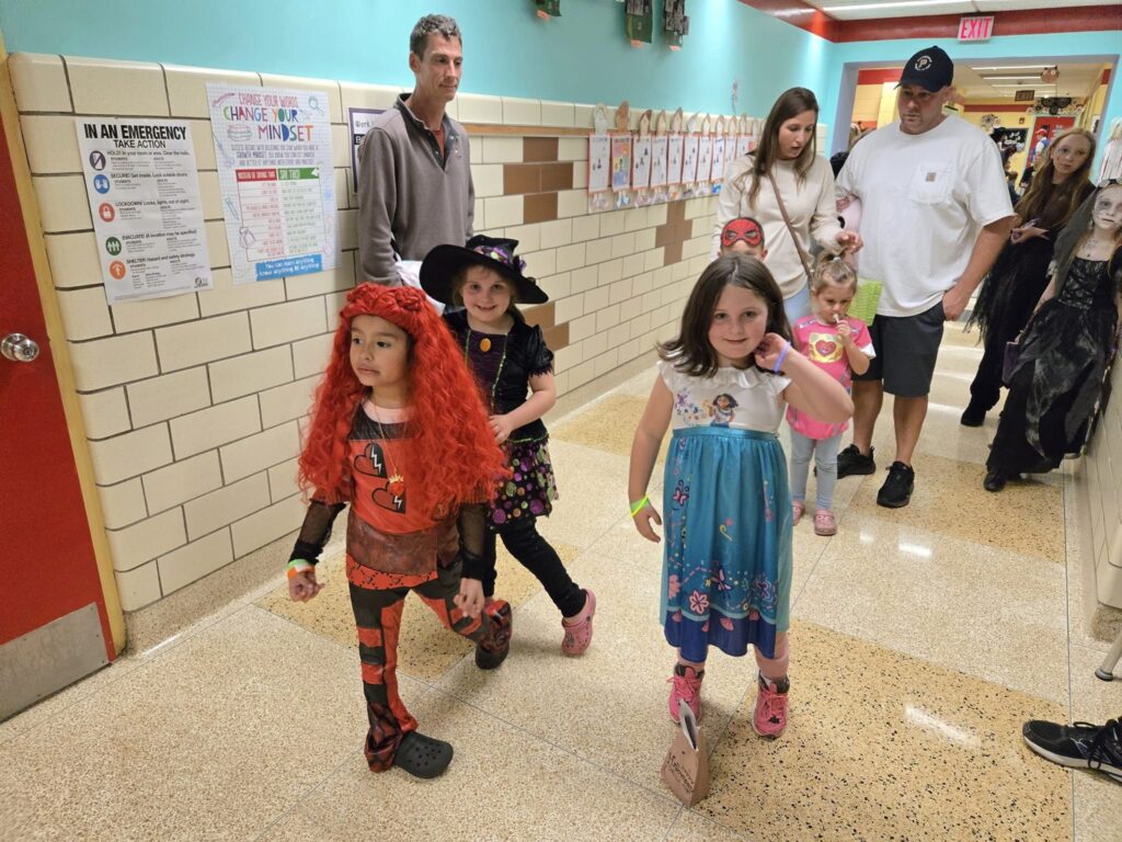 Students stand in hallway in costumes