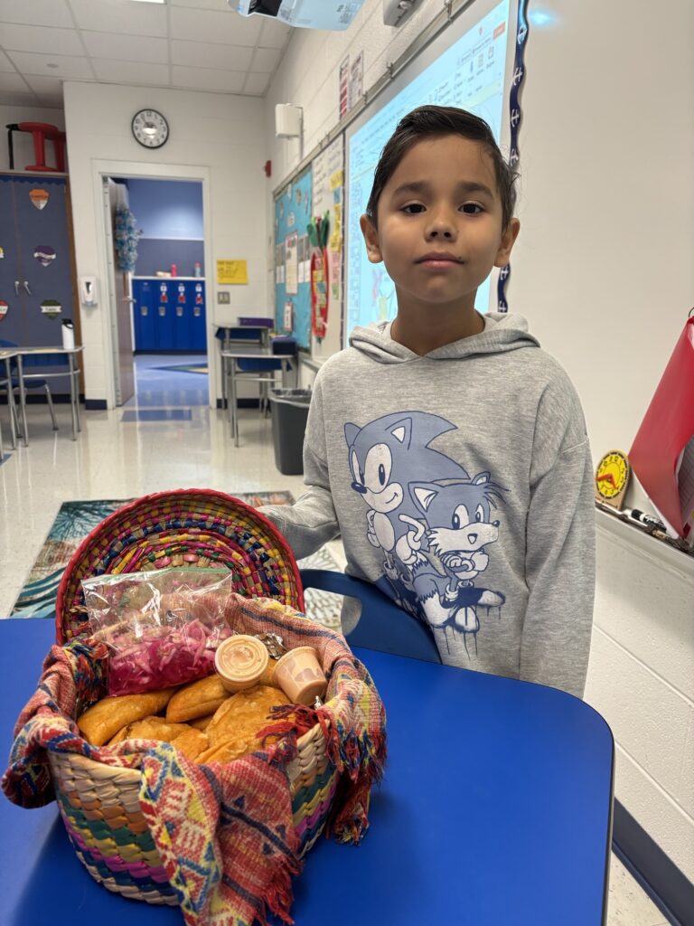 Student stands with the food his mother made