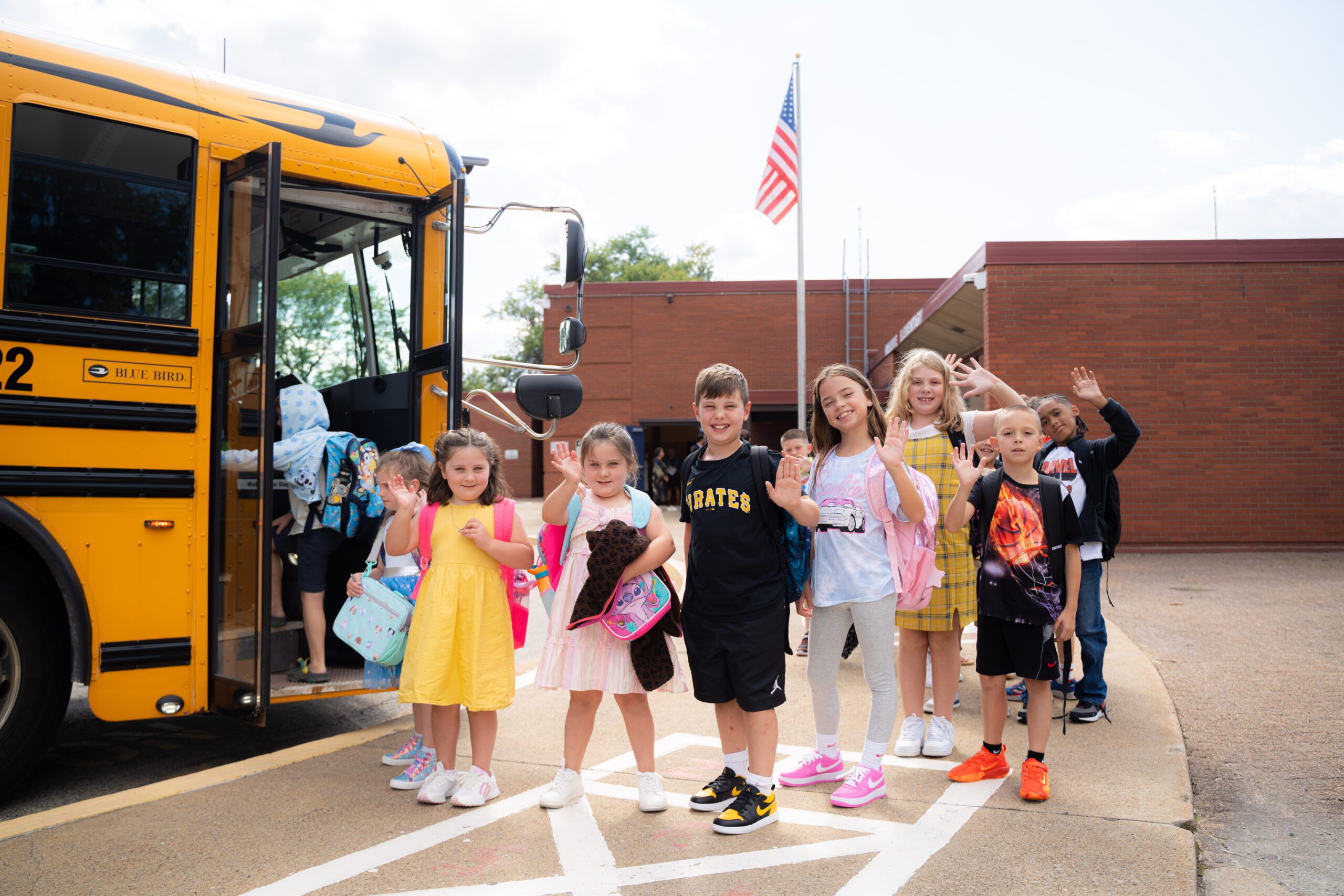 Students at Reserve smile as they board the bus