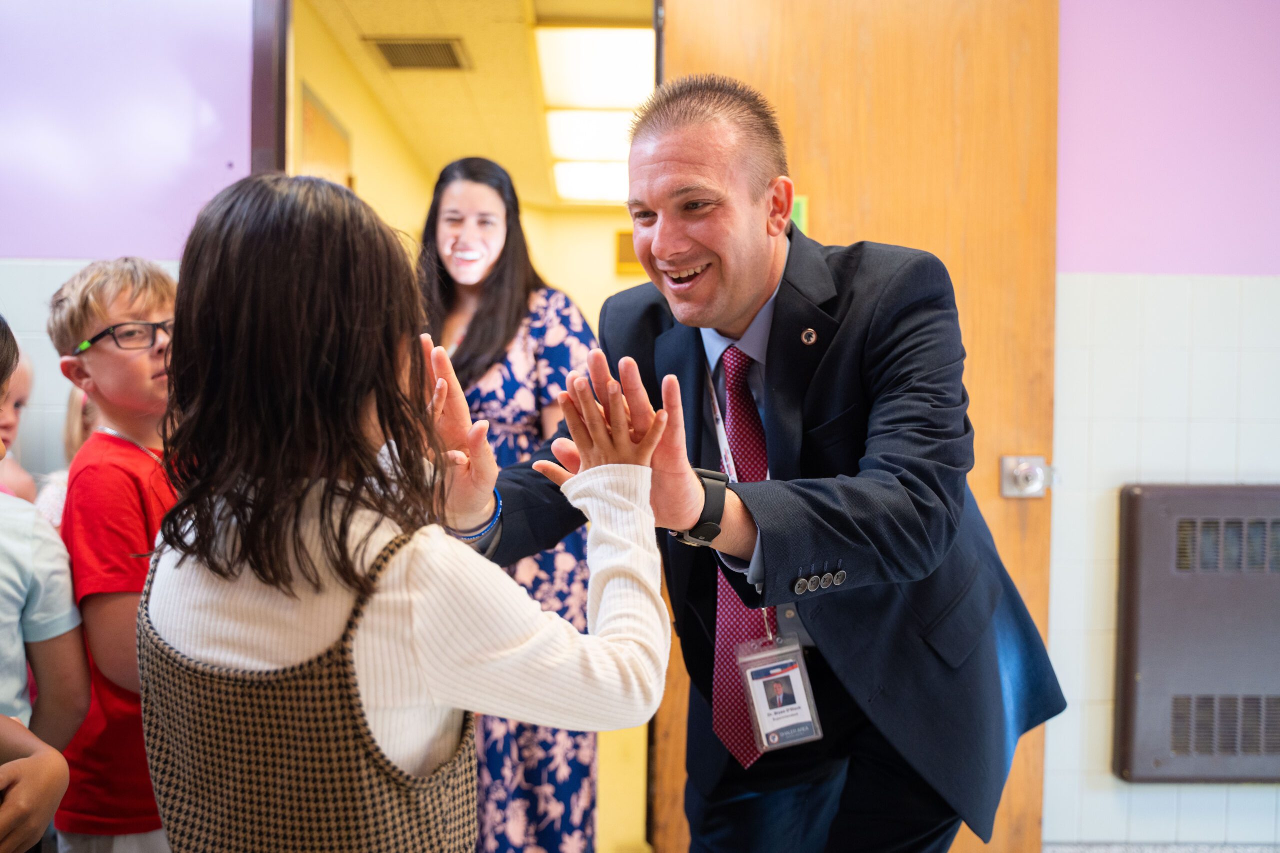 Dr. O'Black high fives a student