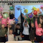 Students wave their balloons