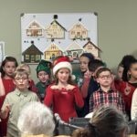 students sing to residents