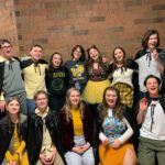 The cast of puffs pose in the high school hallway