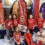 Students pose in red shirts