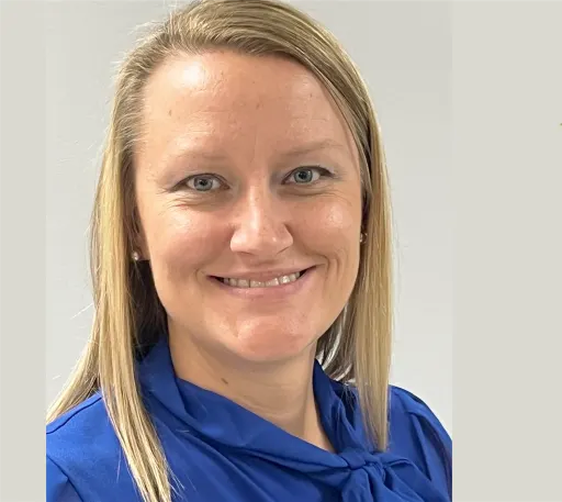 Jennifer Tressler smiles in a blue blouse