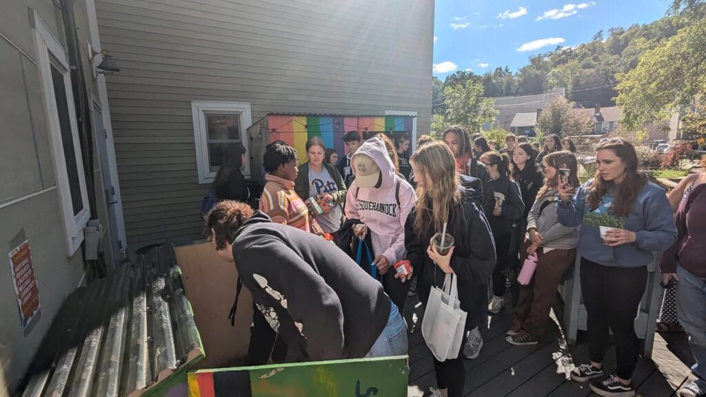 Students place items in the Millvale Food Pantry