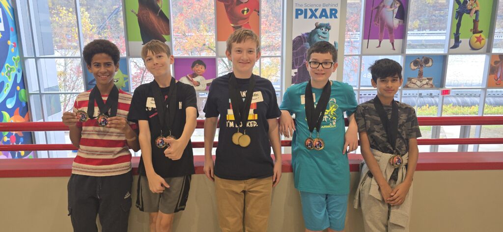 students pose with medals