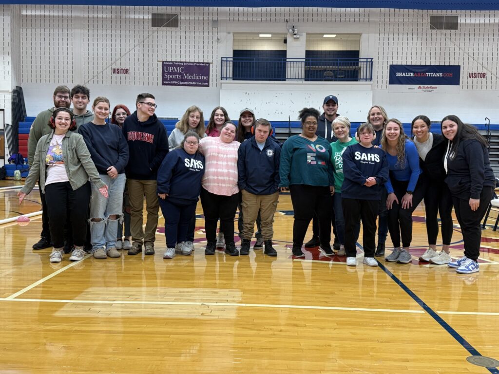 Unified bocce participants smile in the gym