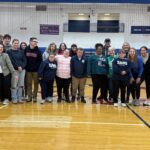 Unified bocce participants smile in the gym