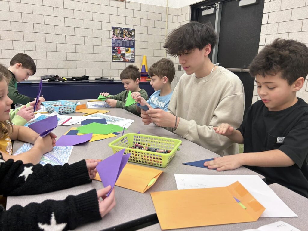 Students practice origami together