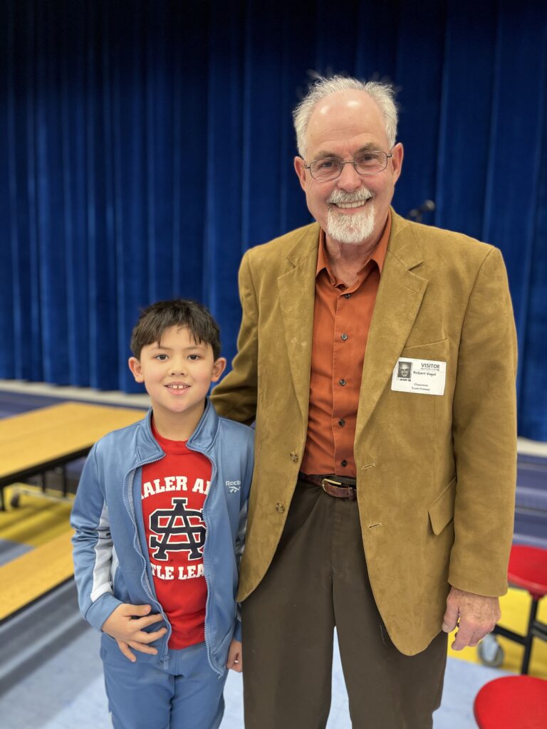 author poses with his grandson