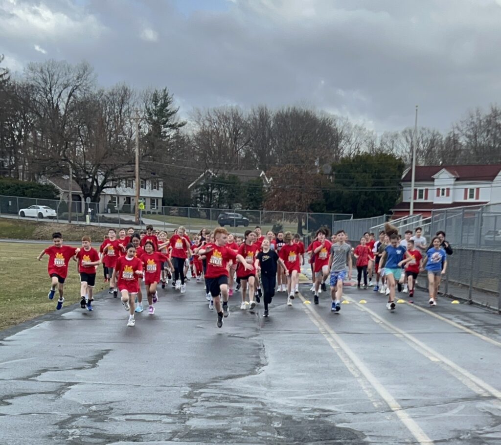 students run around the track