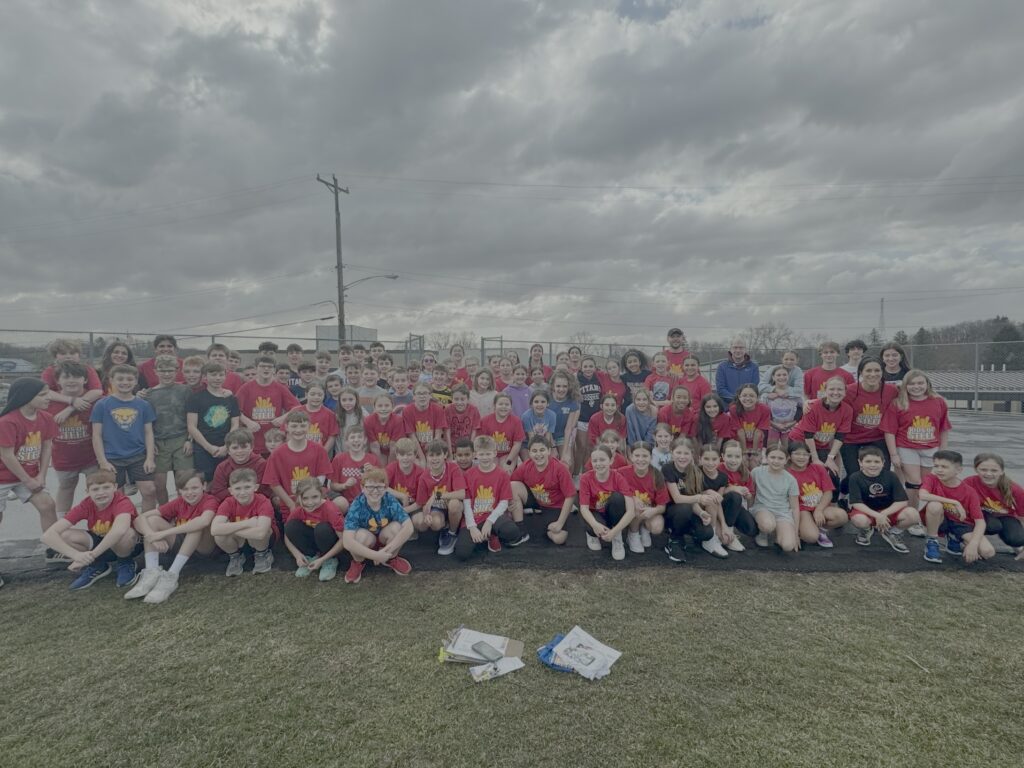 students pose in their running shirts