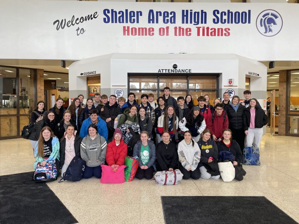 Students pose in the high school lobby