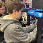 Student works in a 3D printer