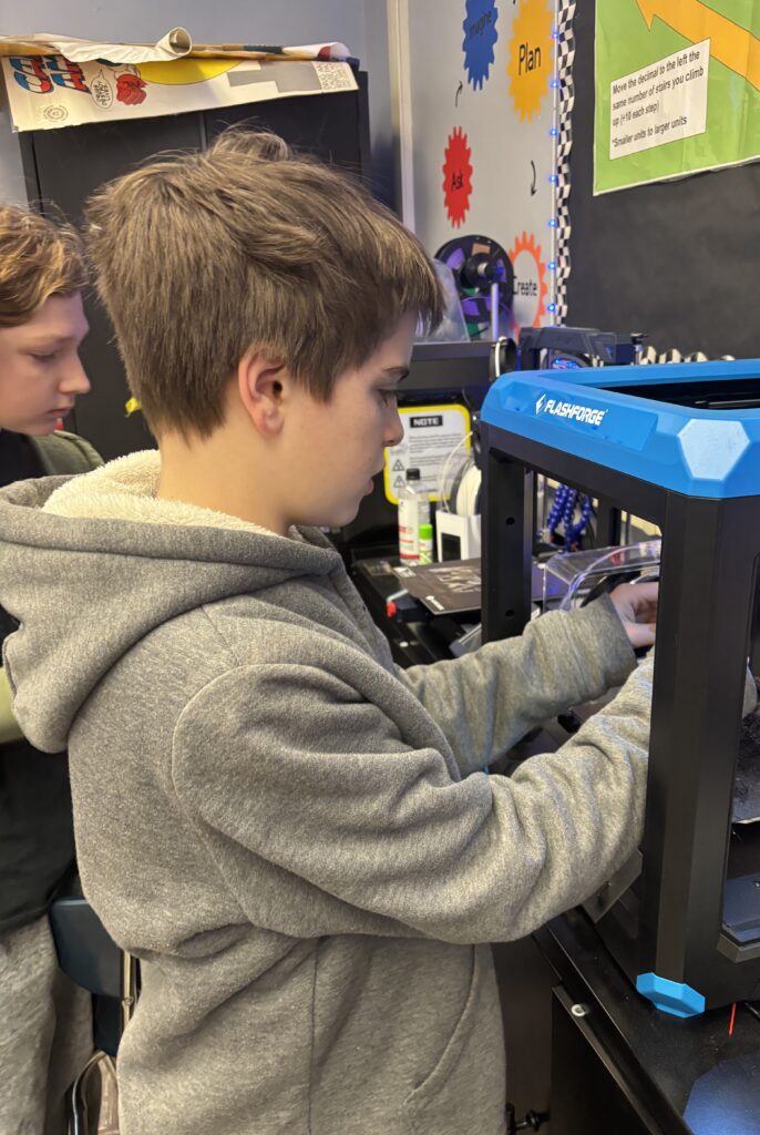 Student works in a 3D printer