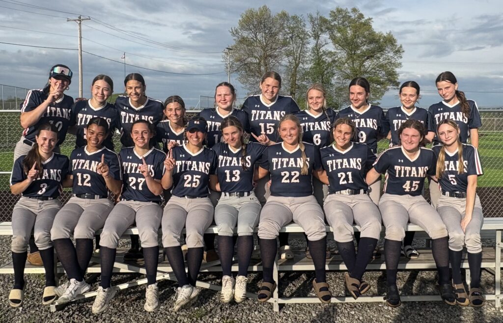 the softball team poses outside