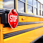 side view of a bus with a stop sign