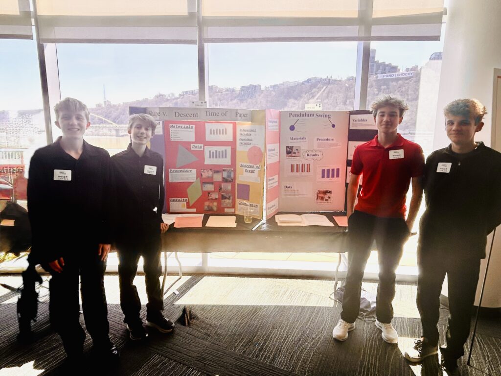 students pose with their poster