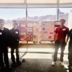 students pose with their poster