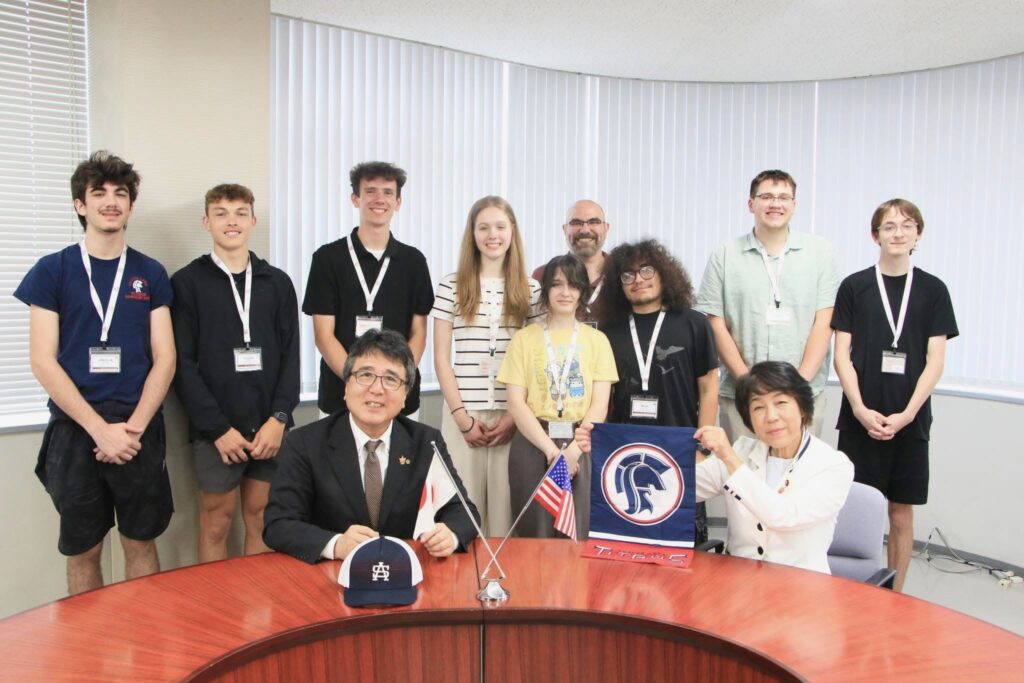 students stand with dignitaries